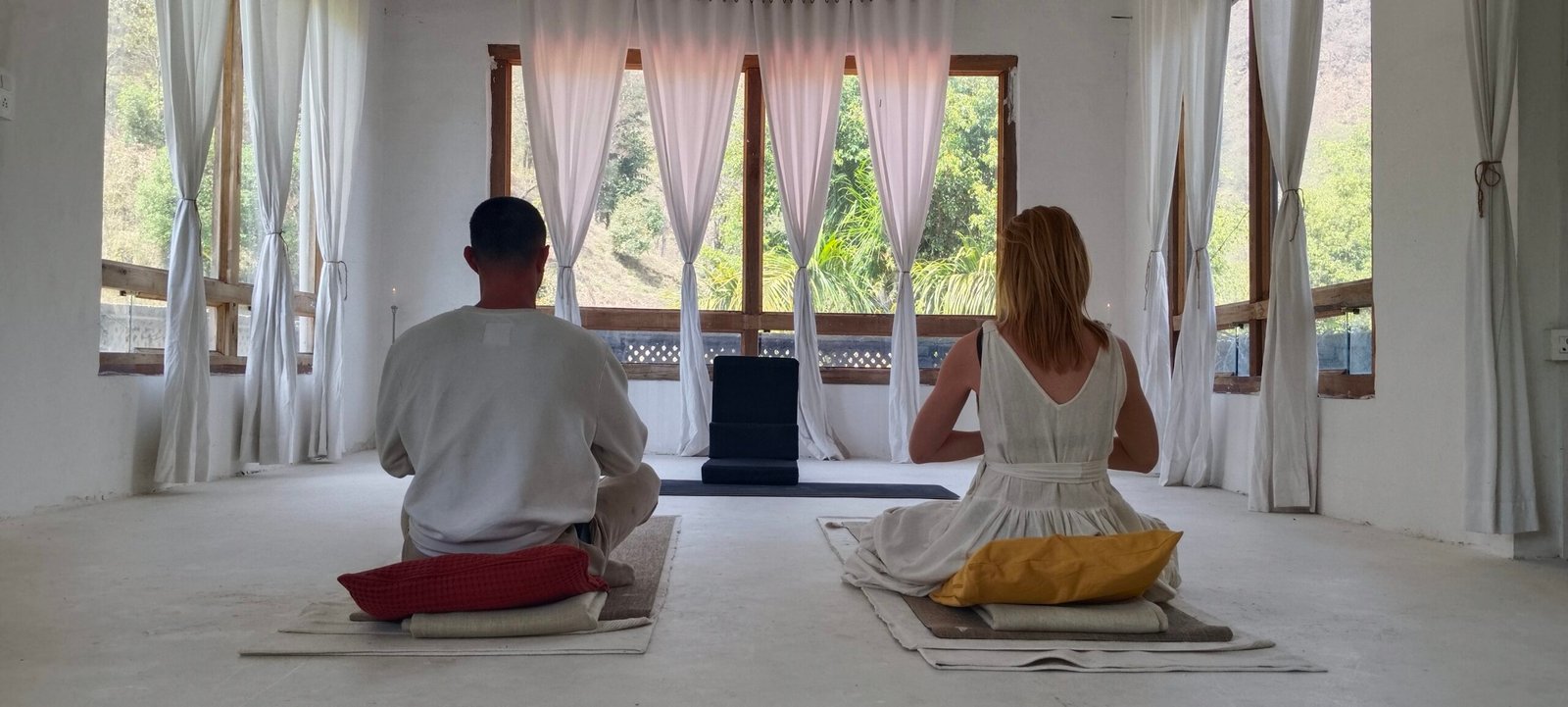 Carolina and Yogi Rohan seated together in meditation